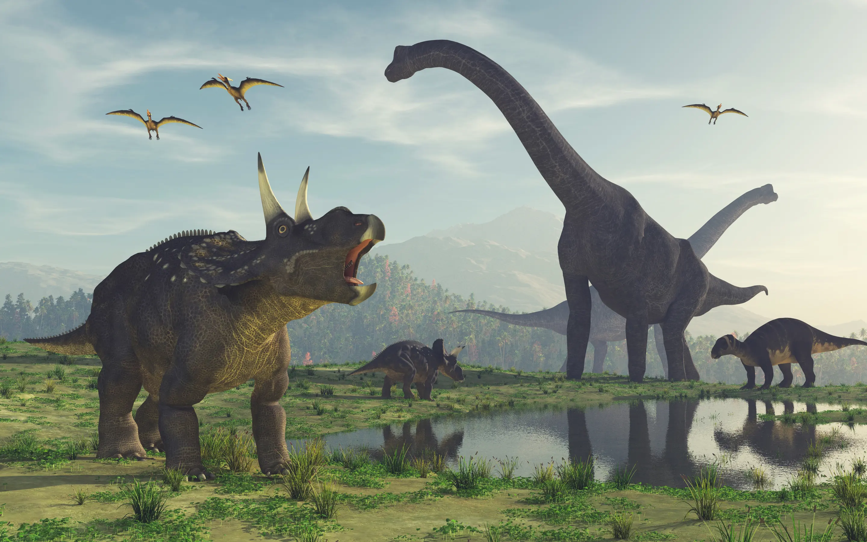 Several dinosaurs standing near a lake, with lush greenery in the background